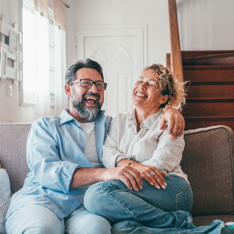 couple laughing on couch